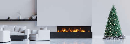 Black and white midern living room with fireplace, christmas tree with presents. 3D render. 3D illustration.の写真素材