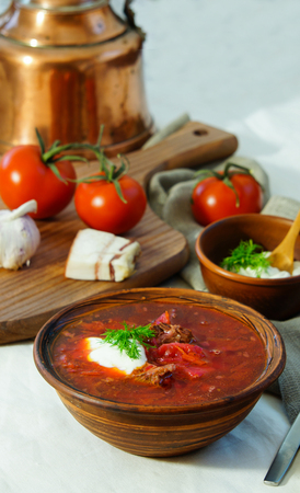 Homemade Russian, Ukrainian and Polish national soup - red borscht made of beetrot, vegetables and meat with sour cream Top view.の写真素材