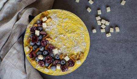 Raw vegan berry and mango cheesecake gluten-free on a white wooden background, coconutの写真素材