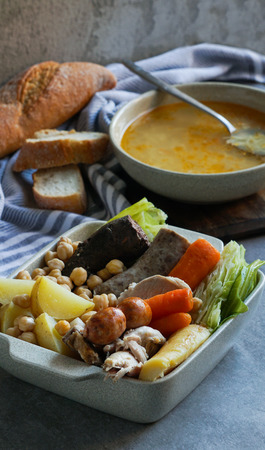 Cocido, traditional chickpea-based stew from Madrid.  on the grey stone backgroundの写真素材