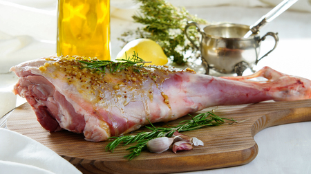 lamb leg raw with olive oil and mustard seeds marinadeの写真素材