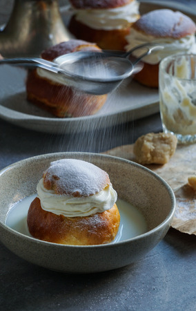 Semla or semlor, vastlakukkel, laskiaispulla is a traditional sweet roll made in various forms in Sweden, Finland, Estonia, Norway, Denmark, especially Shrove Monday and Shrove Tuesdayの写真素材