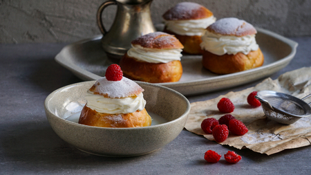 Semla or semlor, vastlakukkel, laskiaispulla is a traditional sweet roll made in various forms in Sweden, Finland, Estonia, Norway, Denmark, especially Shrove Monday and Shrove Tuesdayの写真素材