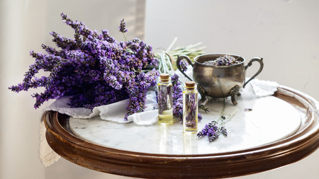 lavender oil bottles,  natural herb cosmetic consept with lavender flowers flatlay on stone backgroundの写真素材