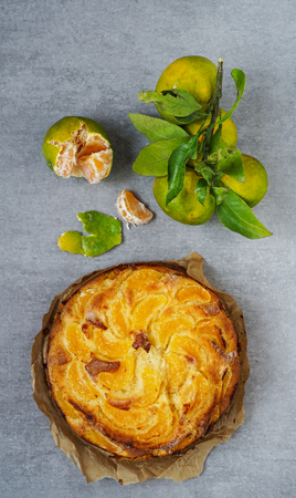 tangerine cake on the grey stone background, top view, flat layの写真素材