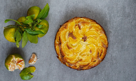 tangerine cake on the grey stone background, top view, flat layの写真素材
