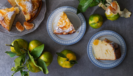 tangerine cake on the grey stone background, top view, flat layの写真素材