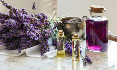 lavender oil bottles,  natural herb cosmetic consept with lavender flowers flatlay on stone backgroundの写真素材