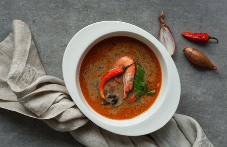 Tom Yam kung Spicy Thai soup with shrimp, seafood, coconut milk and chili pepper in bowl copy spaceの写真素材