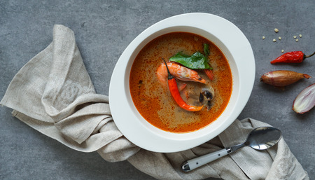 Tom Yam kung Spicy Thai soup with shrimp, seafood, coconut milk and chili pepper in bowl copy spaceの写真素材