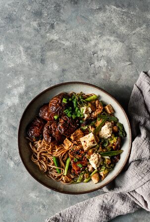 asian vegan soba noodle  with tofu cheese,shiitake mushroms, top view, copy spaceの写真素材