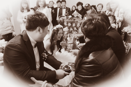 CHINA NANCHANG February 26, 2015: the bride and groom offer tea to the parentsのeditorial素材