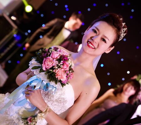 CHINA NANCHANG February 26, 2015: Beautiful happy bride holding flowersのeditorial素材