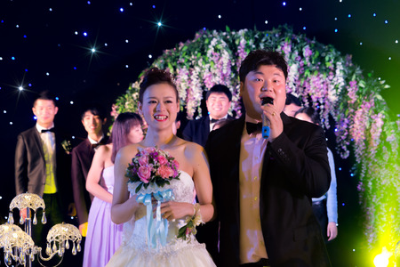 CHINA NANCHANG February 26, 2015: the bride and groom in a speech to the guests on stageのeditorial素材