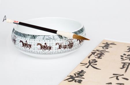 Calligraphy brush and ceramic bowlの写真素材