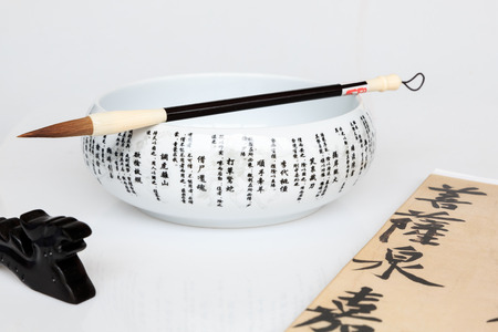 Calligraphy brush and ceramic bowlの写真素材
