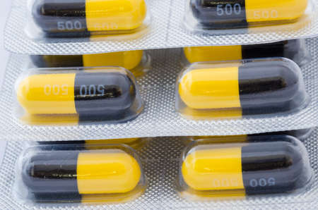 Black and yellow capsule pack medicine heath conceptの写真素材