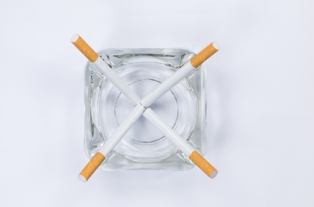 cigarettes with a brown filter macro shot in white backgroundの写真素材