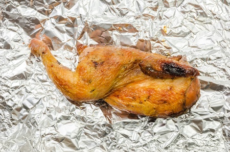 Roasted chicken food on aluminum foil close up macrp shotの写真素材