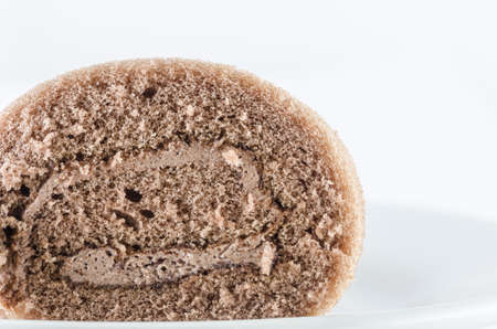 Roll chocolate cake and cream on white backgroundの写真素材