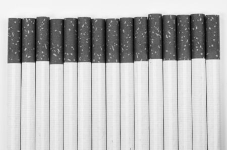 cigarettes with a brown filter macro shot in white backgroundの写真素材