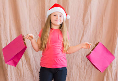 Happy girl holds packages with gift for advent holiday Merry Christmas and Happy New Yearの写真素材