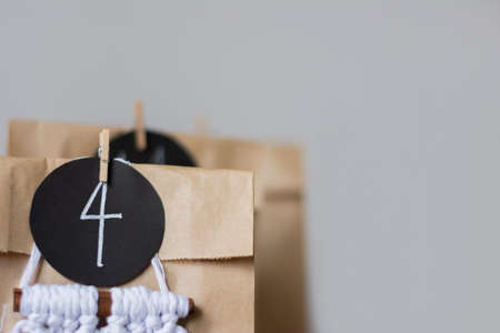 Close-up christmas advent calendar from kraft paper in gray background eco zero waste copy