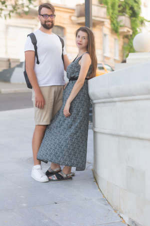 Positive heterosexual couple in love walking in the city in summer weekend hiking health freedomの写真素材