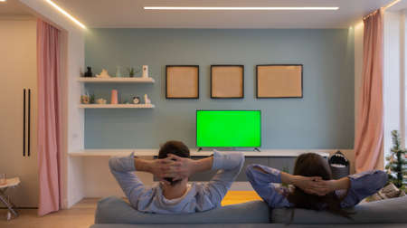 Caucasian man and woman couple in love view from the back no face looking at green screenの写真素材