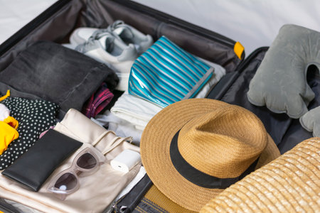 Close-up of an open suitcase packing travel suitcase on floor at home no peopleの写真素材