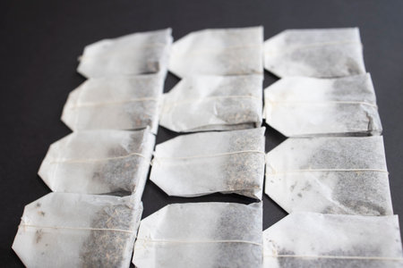 Lots of tea bags on a black backgroundの写真素材
