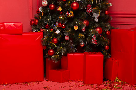 Close-up of colored red big gifts under the Christmas tree no peopleの写真素材