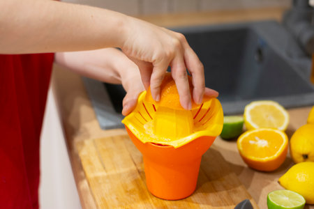 squeezing an orange. DIY summer cooling drinkの写真素材