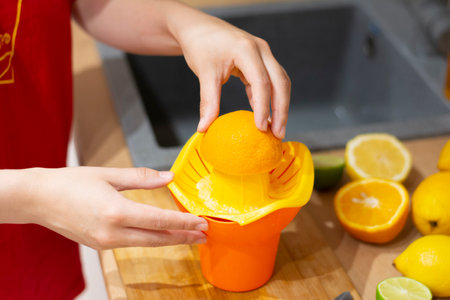 squeezing an orange. DIY summer cooling drinkの写真素材