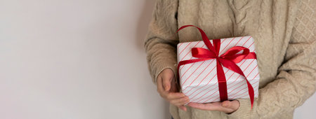 gift wrapped in a white-red striped gift wrapping against a white backgroundの写真素材