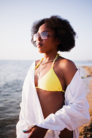 Afro american woman in yellow swimsuitの写真素材