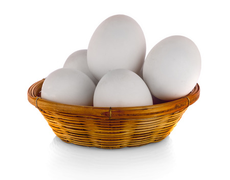 Duck eggs in a basket on white backgroundの写真素材