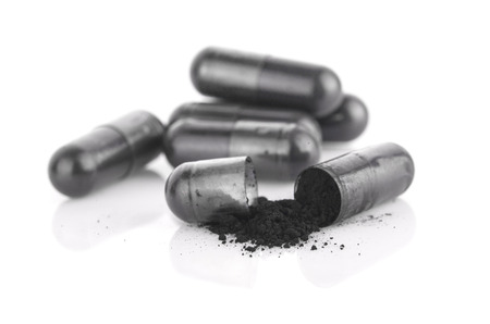 Charcoal capsules on isolated on white backgroundの写真素材