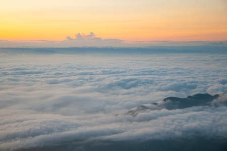 top of the mountain over the fogの写真素材