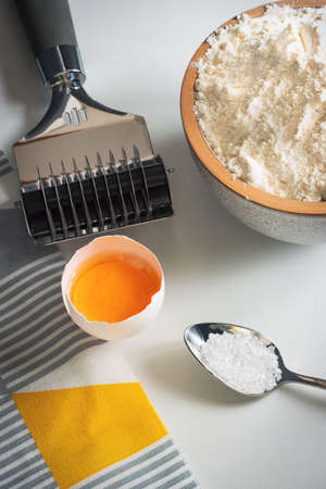 still life cooking pasta flour, egg, salt, pasta knife on the table