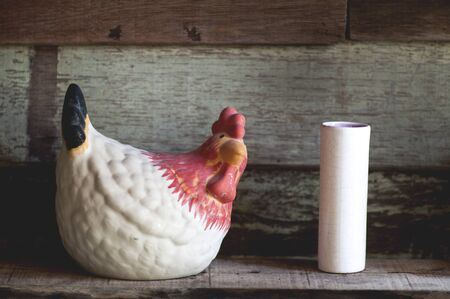 Chicken pots are placed next to white candles.の写真素材