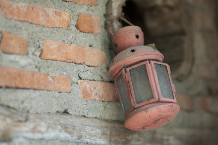The red lantern was hanging from a brick wall.の写真素材