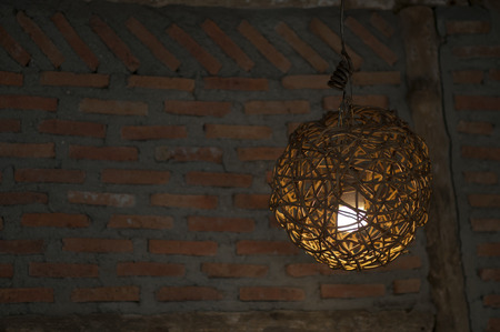 The light is illuminated in the lamps made of bamboo weave together.の写真素材