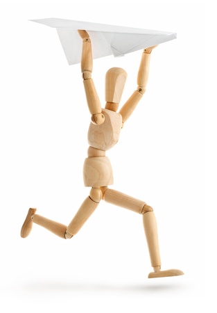 wooden man running with paper airplane isolated on white backgroundの写真素材