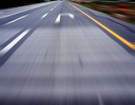 slow down and u turn sign on the road with high speed effectの写真素材