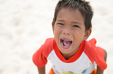 Semporna, Malaysia - Sep 29, 2014  A Bajau kid shouting and smiling with open mouth and sugar teeth, shot on Mabul island, Semporna, Sabah, Maylaysia  Bajau people are also referenced as the last sea gypsies,  sea-oriented, boat-dwelling, nomadic, and no のeditorial素材
