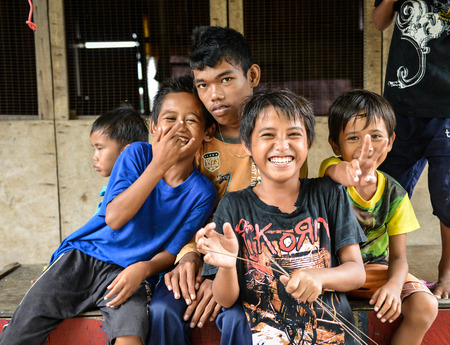 Semporna, Malaysia - Oct 2, 2014    A group of poor little Bajau boys having funs in front of camera on street, shot on Mabul island, Semporna, Sabah, Maylaysia  Bajau people are also referenced as the last sea gypsies,  sea-oriented, boat-dwelling, nomadのeditorial素材