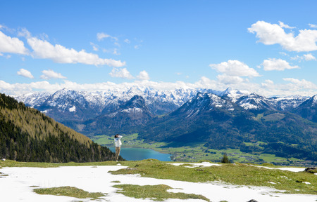 Single young Chinese woman walking by the edge of Schafberg mountain  , Austriaの写真素材