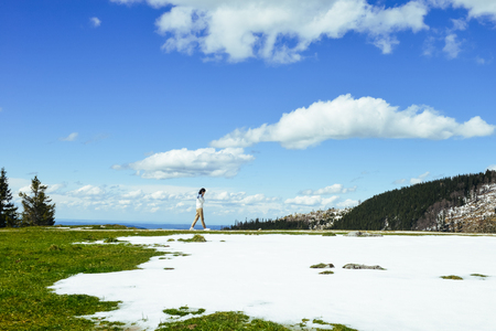 Single young Asian woman walking at edge of Schafberg mountain   , Austriaの写真素材