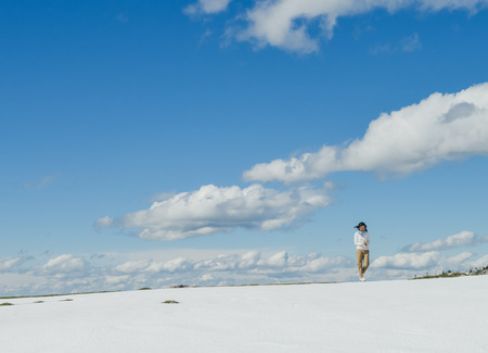 Single young Asian woman standing at edge of Schafberg mountain  , Austriaの写真素材